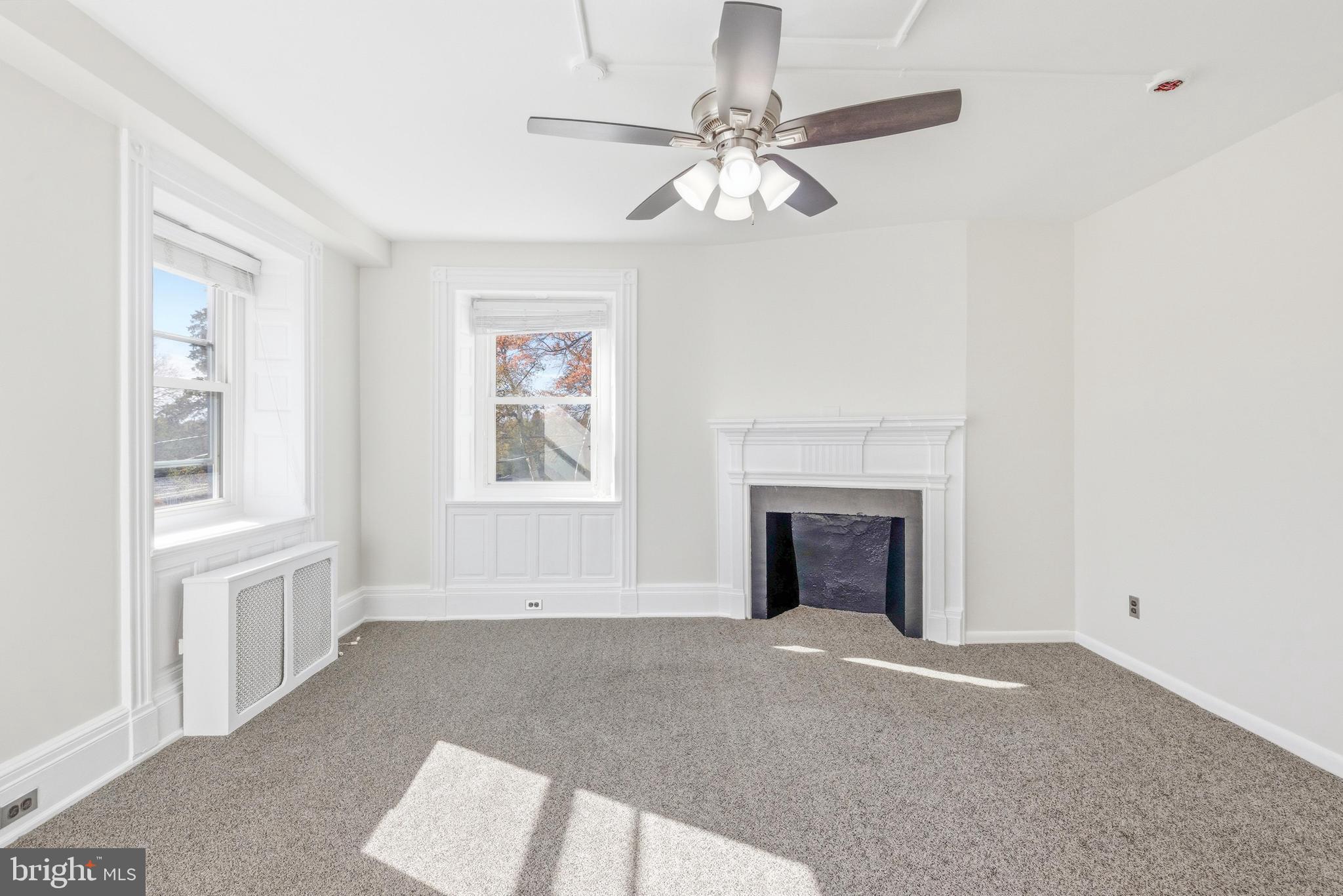 1834 Meetinghouse Road, Unit 1458 Upper Chichester, PA 19061 - Photo 26 of 42 wooden floor fireplace and windows in an empty room