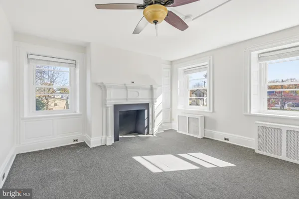 a view of empty room with window and fireplace