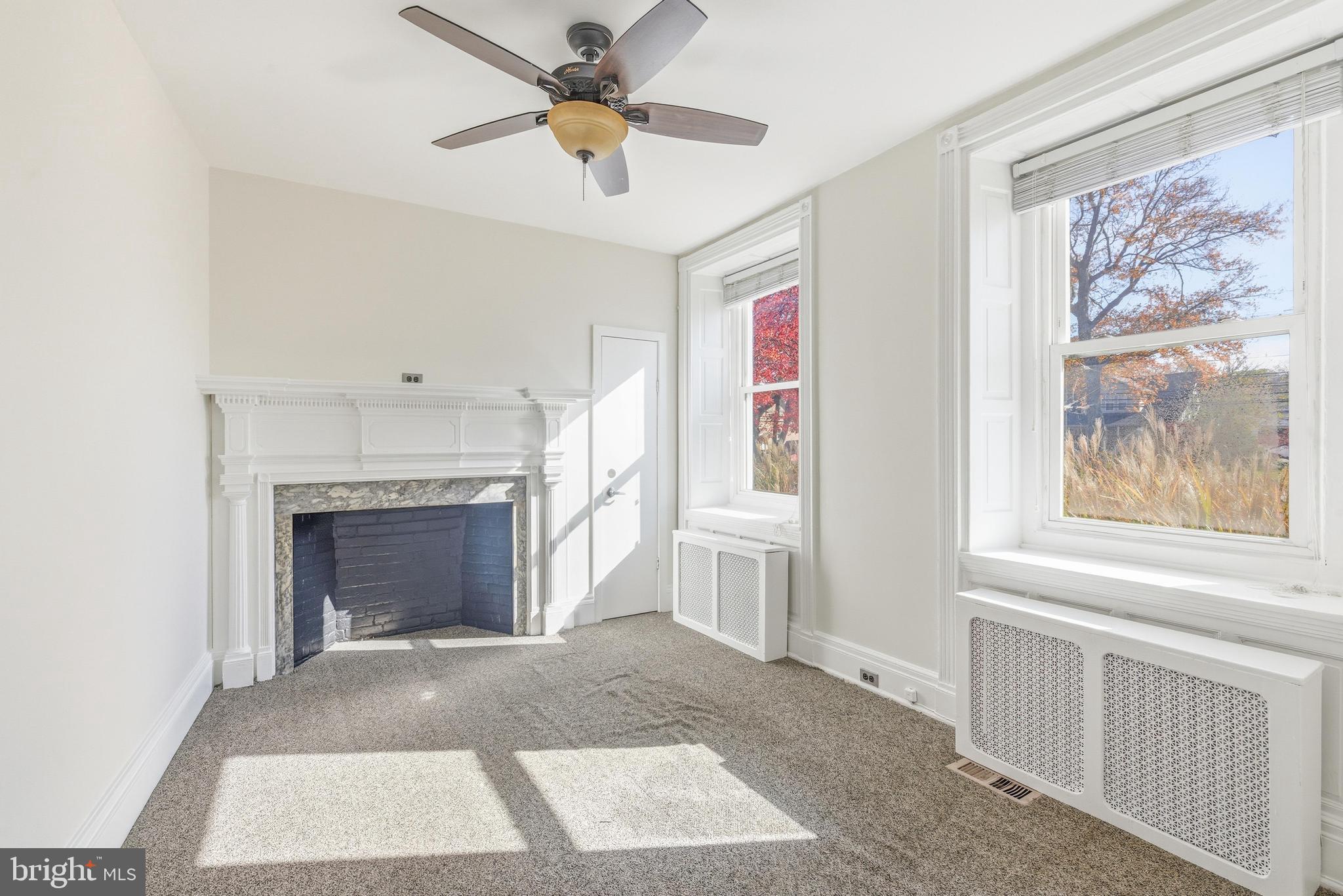 1834 Meetinghouse Road, Unit 1458 Upper Chichester, PA 19061 - Photo 29 of 42 a view of livingroom with furniture a fireplace and window