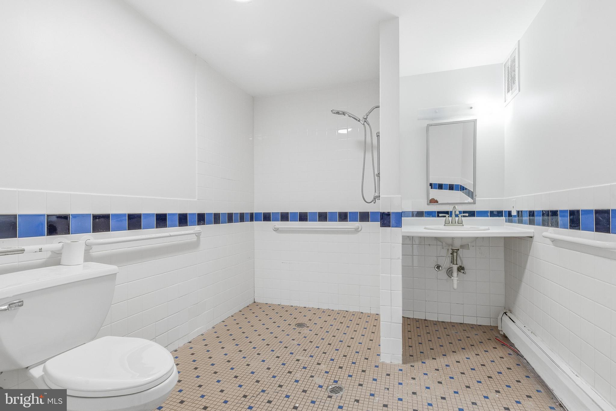 1834 Meetinghouse Road, Unit 1458 Upper Chichester, PA 19061 - Photo 32 of 42 a bathroom with a sink a toilet a vanity and mirror