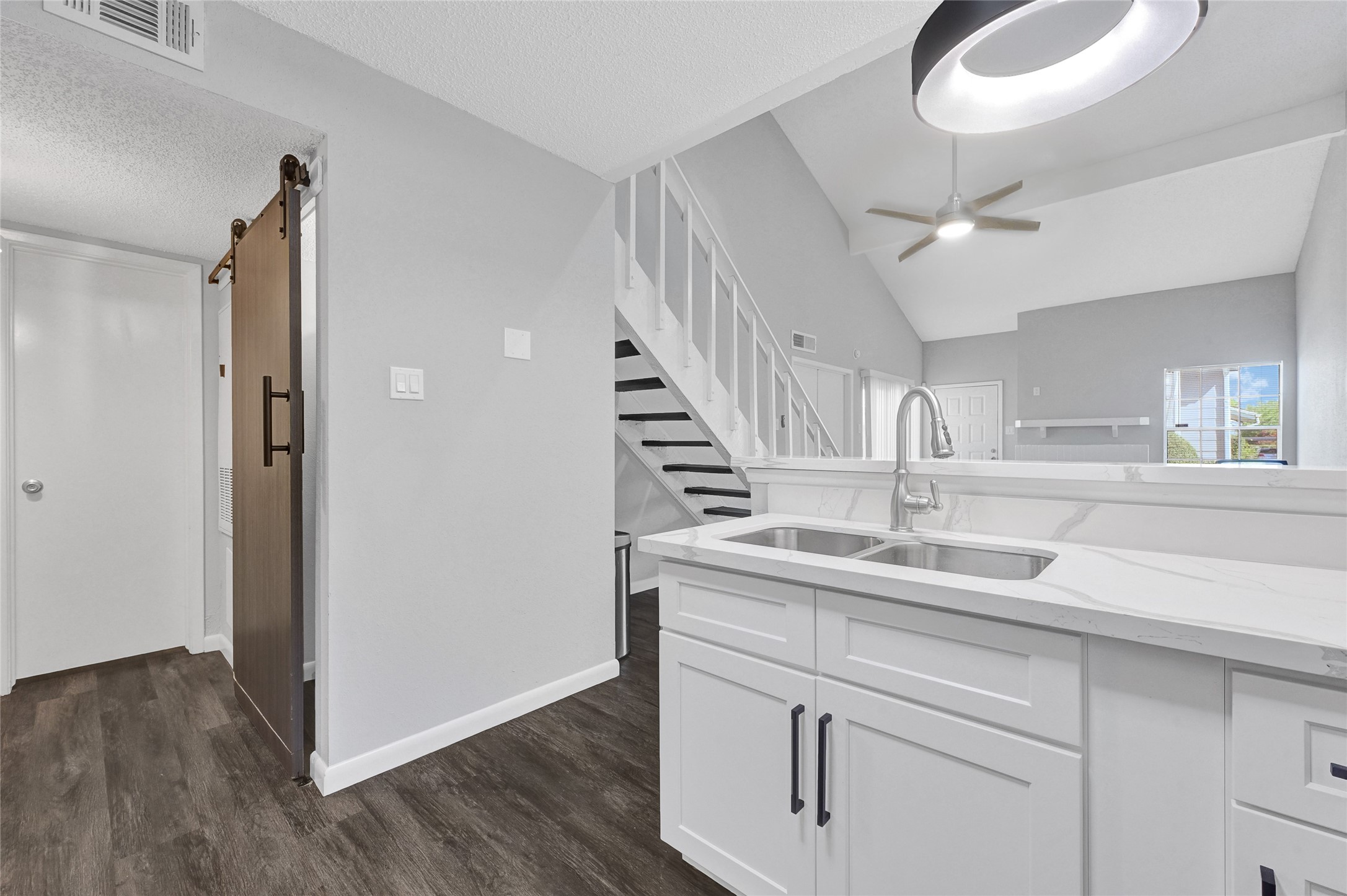 12111 Lemon Ridge Lane, Unit 121 Houston, TX 77035 - Photo 18 of 25 a kitchen with kitchen island a sink and wooden floors