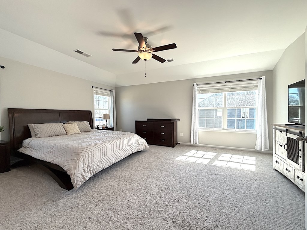 27 Sugar Maple Drive Fort Mitchell, AL 36856 - Photo 15 of 28 a spacious bedroom with a bed and a fireplace