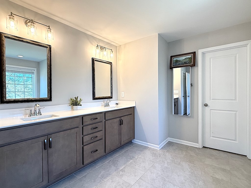 27 Sugar Maple Drive Fort Mitchell, AL 36856 - Photo 16 of 28 a bathroom with a double vanity sink and mirror