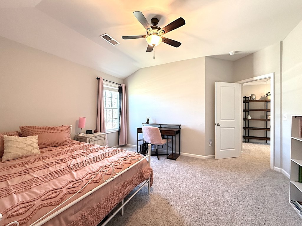 27 Sugar Maple Drive Fort Mitchell, AL 36856 - Photo 19 of 28 a bedroom with a large bed and a chandelier