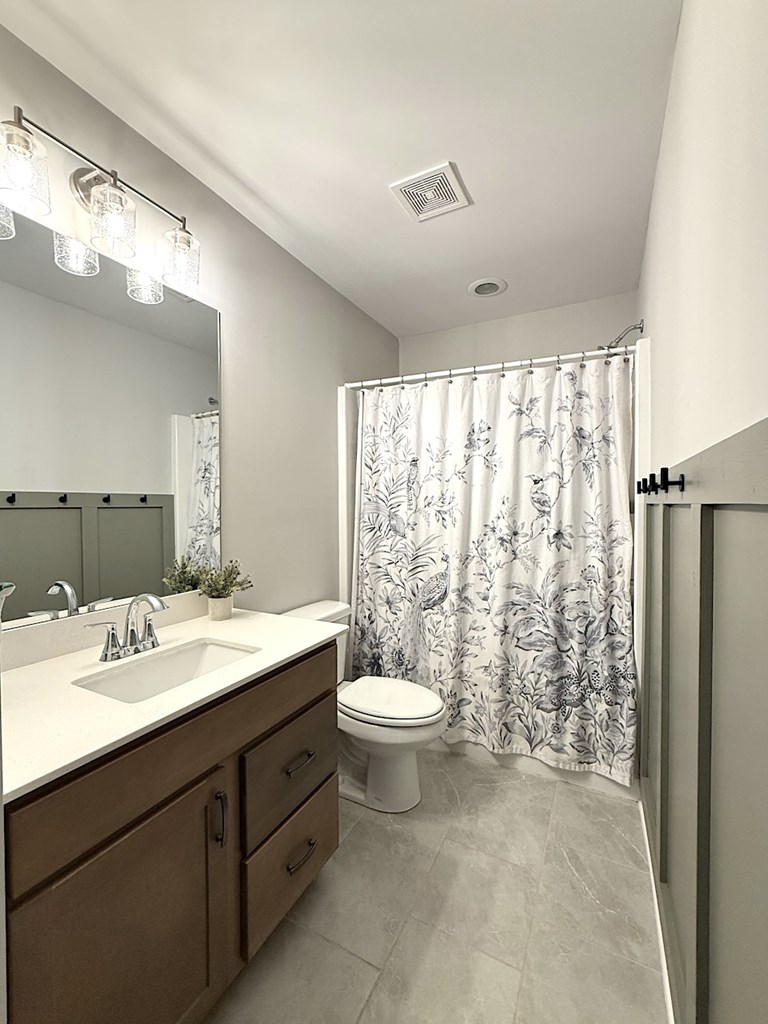 27 Sugar Maple Drive Fort Mitchell, AL 36856 - Photo 20 of 28 a bathroom with a double vanity sink toilet and a mirror