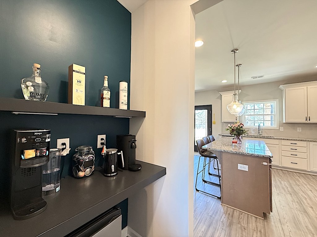 27 Sugar Maple Drive Fort Mitchell, AL 36856 - Photo 6 of 28 a kitchen with kitchen island a counter top space appliances and a view of living room