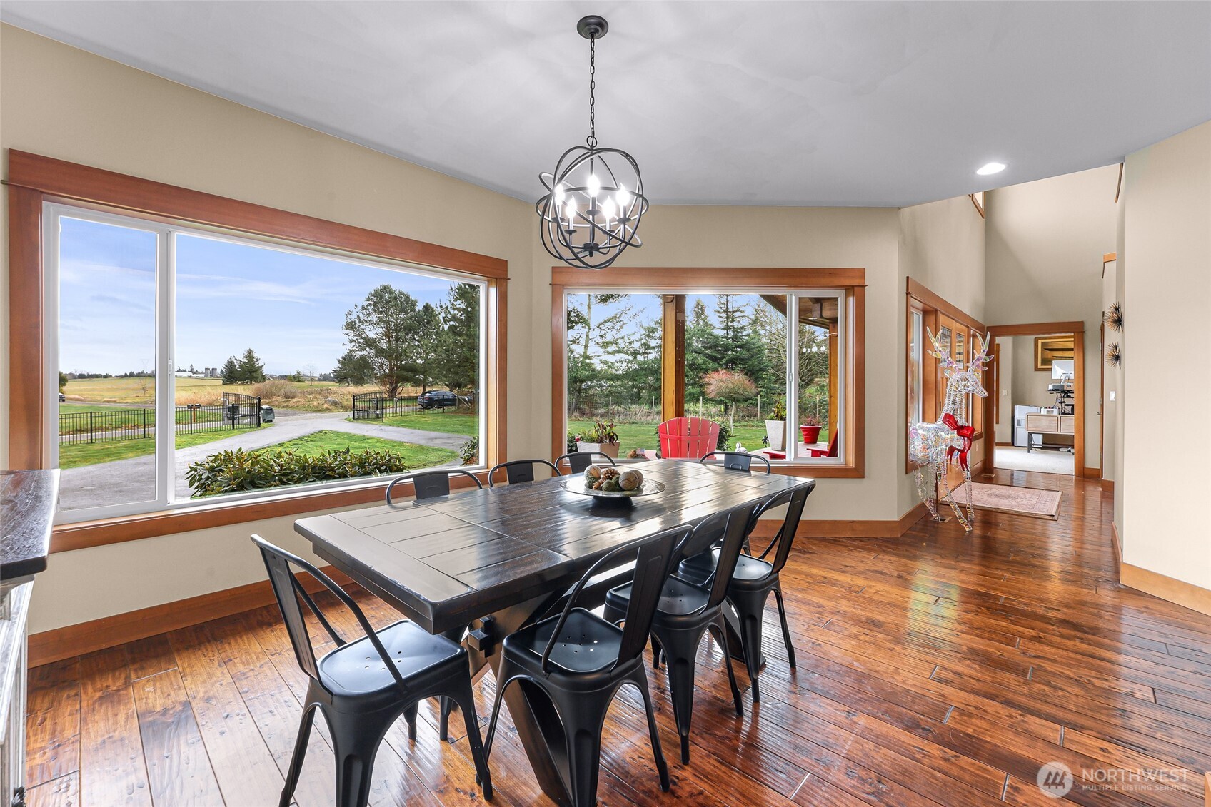7067 Yukon Way Ferndale, WA 98248 - Photo 13 of 40 a view of a dining room with furniture wooden floor and a chandelier