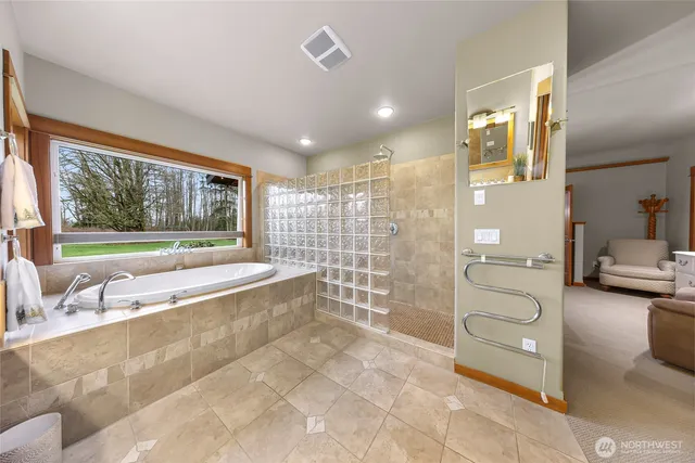 a spacious bathroom with a tub and shower