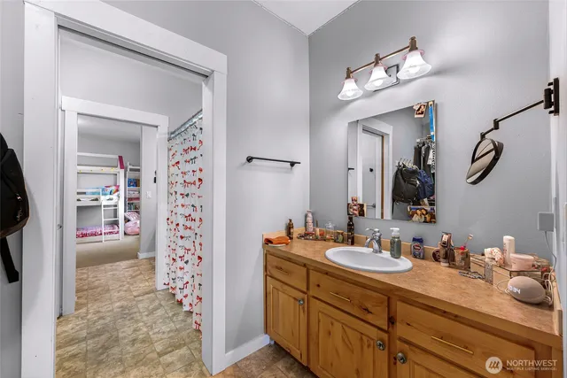 a bathroom with a sink a vanity and a mirror