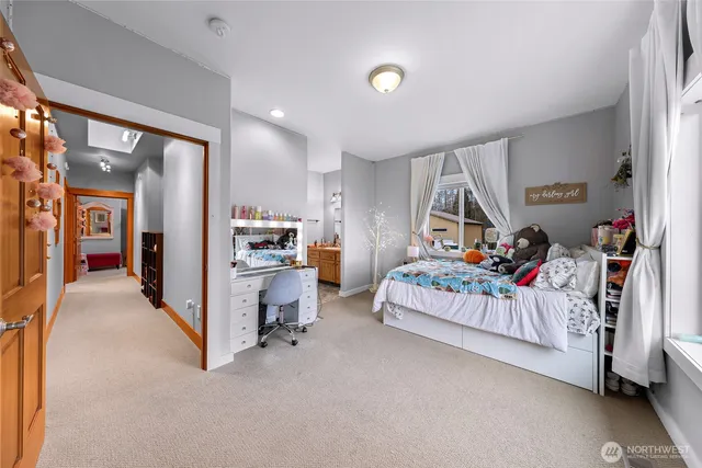 a bedroom with furniture and a book shelf