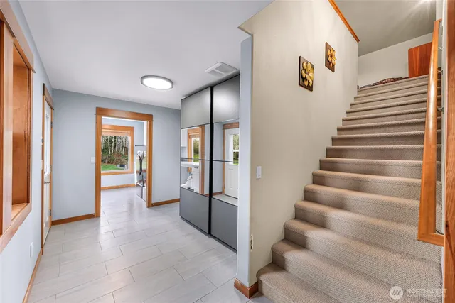 a view of entryway with wooden floor and stairs