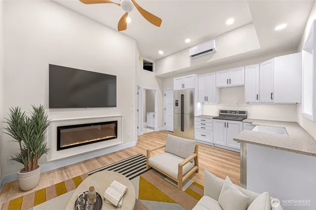 a living room with furniture a flat screen tv and a fireplace