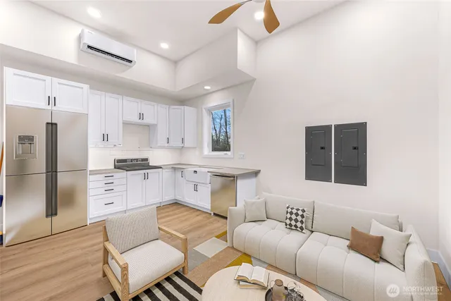 a living room with furniture white walls and kitchen view