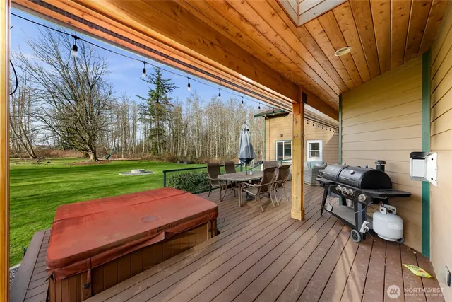 a view of a chairs and table on the wooden deck