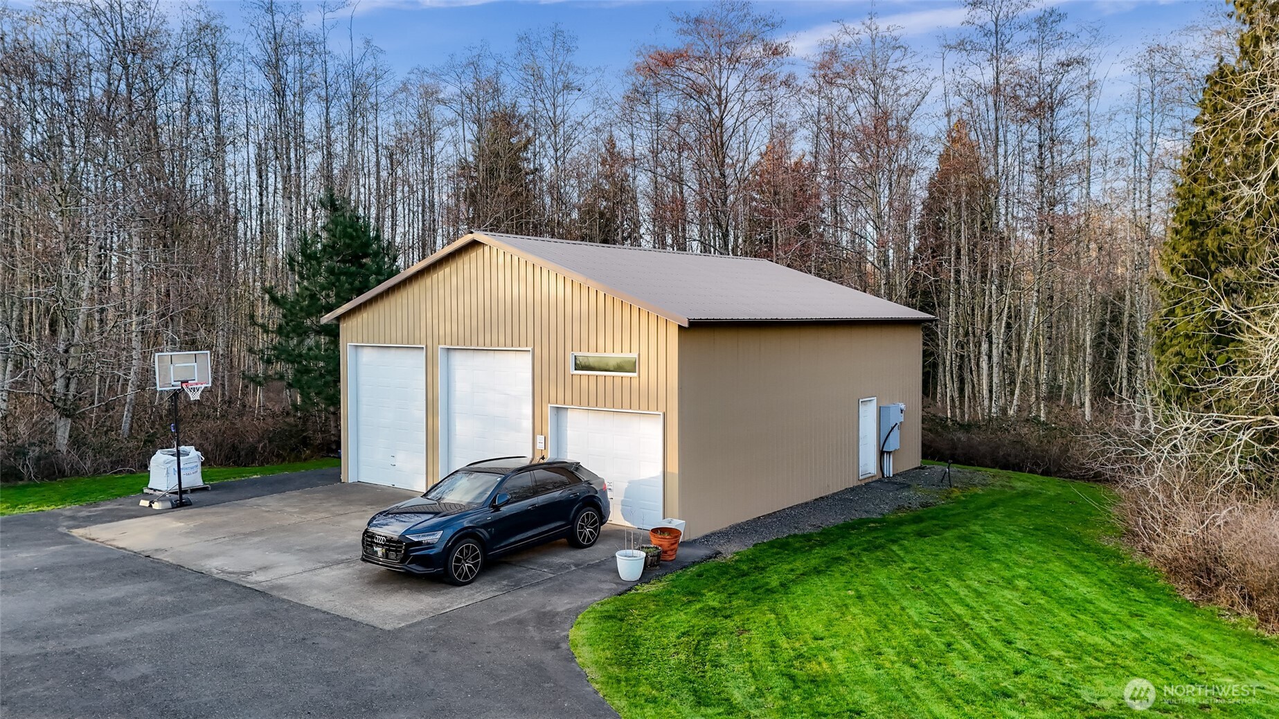 7067 Yukon Way Ferndale, WA 98248 - Photo 39 of 40 a car parked in front of a house with potted plants
