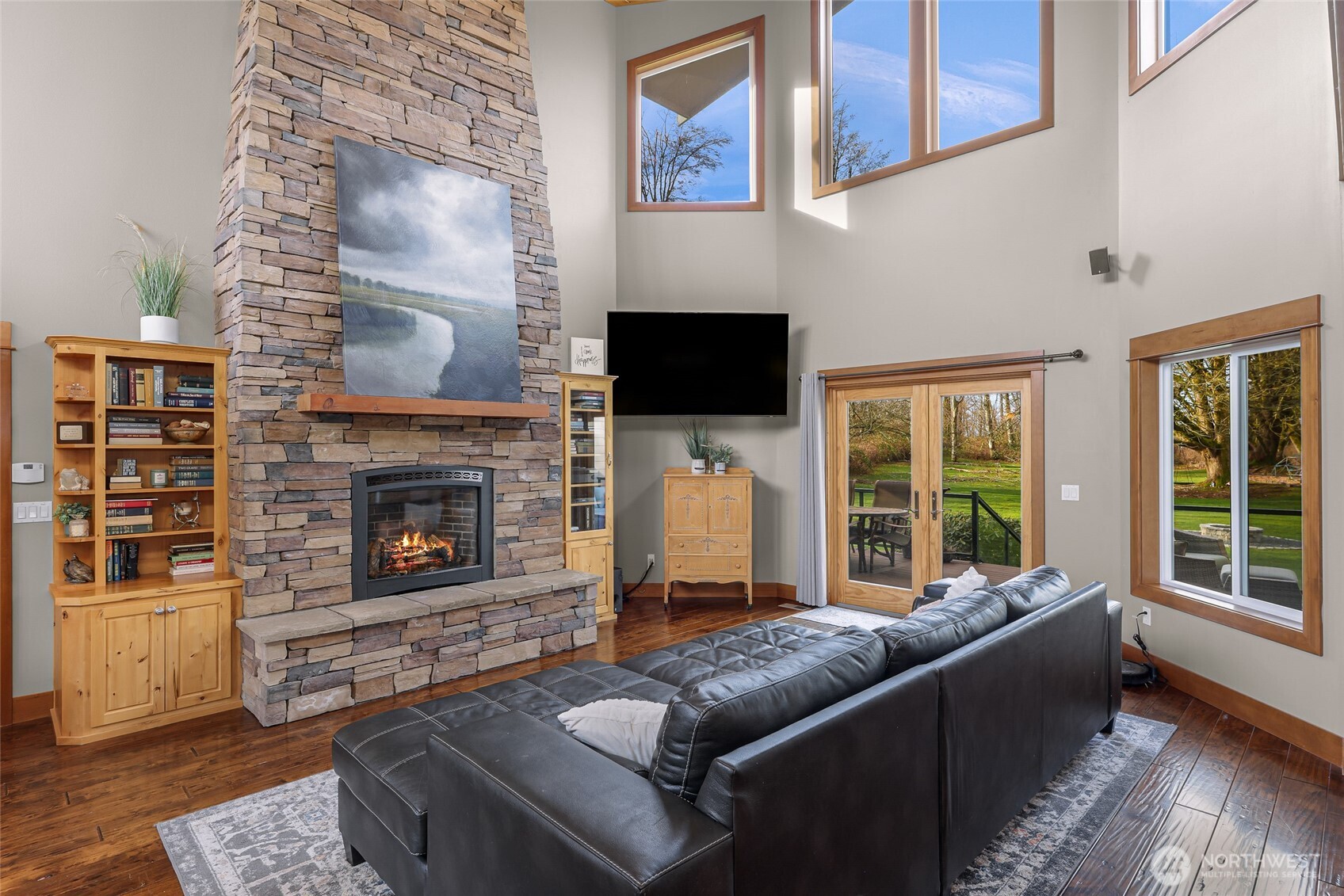 7067 Yukon Way Ferndale, WA 98248 - Photo 5 of 40 a living room with furniture a flat screen tv and a fireplace
