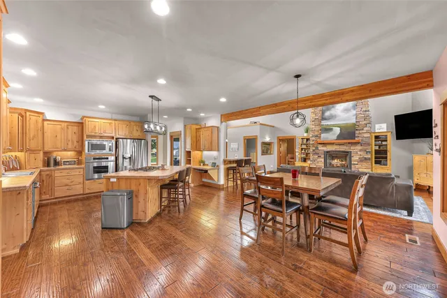 an outdoor space with lots of furniture and wooden floor