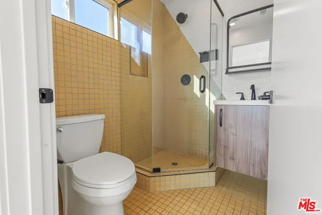 a bathroom with a toilet and shower