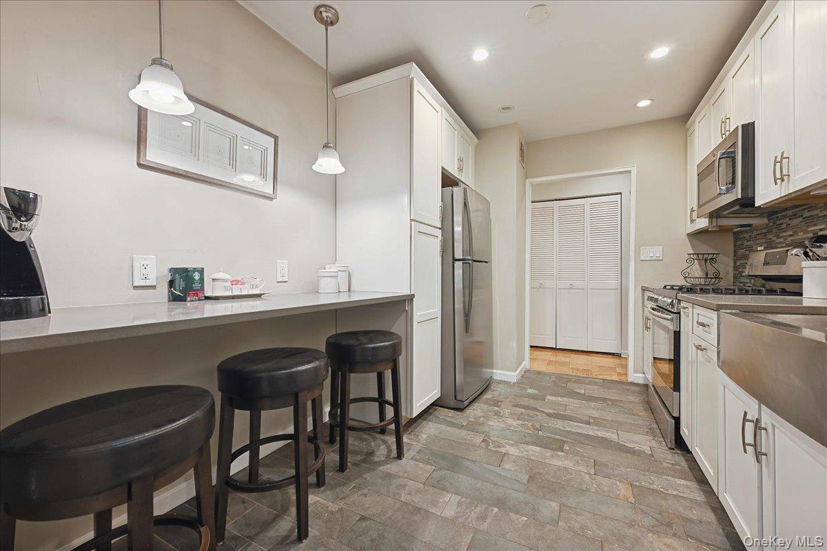 700 Shore Road, Unit 4O Long Beach, NY 11561 - Photo 12 of 42 a kitchen with stainless steel appliances granite countertop a refrigerator and a sink