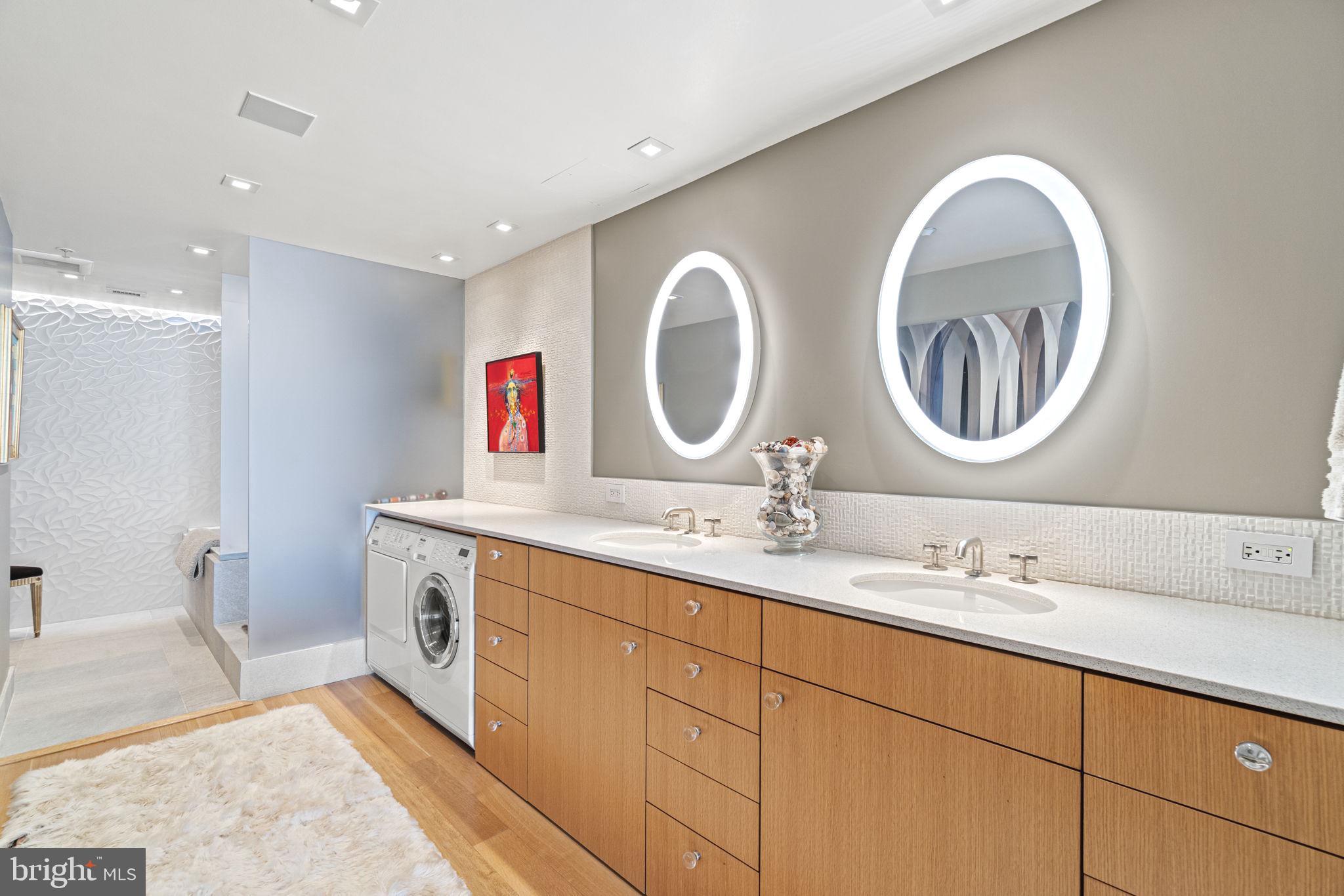 912 F Street Northwest, Unit 1100 Washington, DC 20004 - Photo 13 of 23 a bathroom with a double vanity sink and a mirror