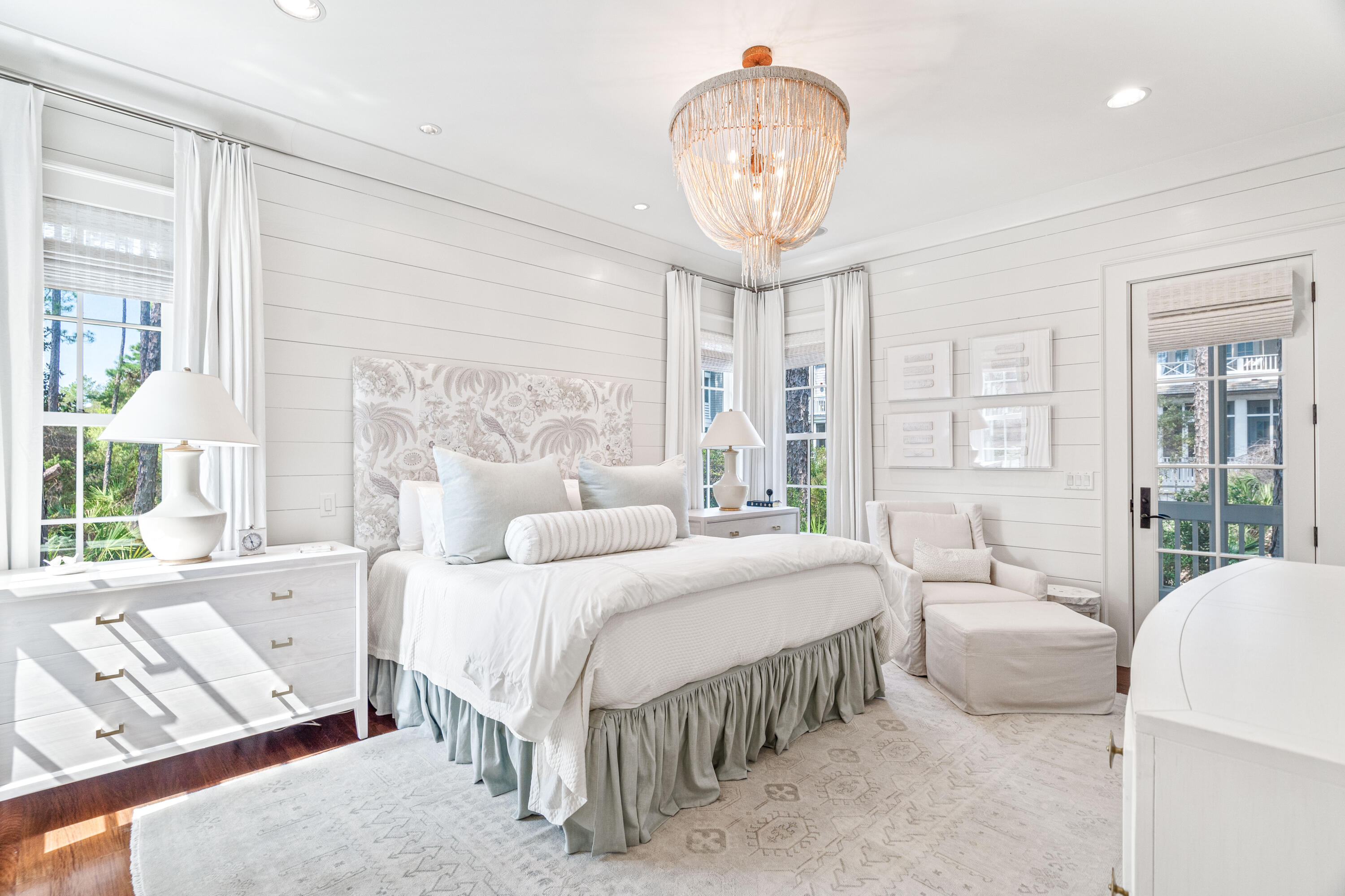 8 Shingle Lane Watersound, FL 32461 - Photo 18 of 73 a bedroom with a large bed and a chandelier