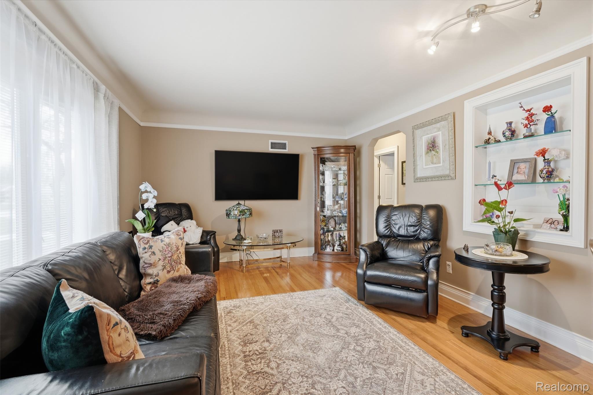 Living room featuring light wood-style floors and arched walkways