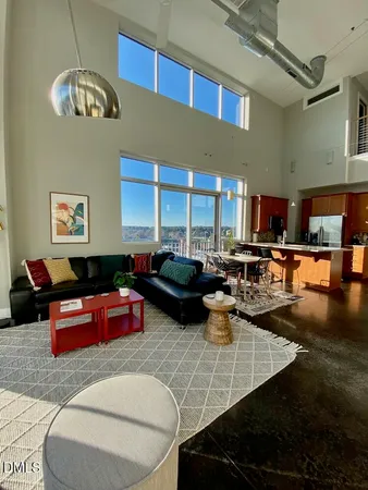 a living room with lots of furniture and kitchen view