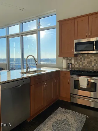 a kitchen with granite countertop a sink and a stove