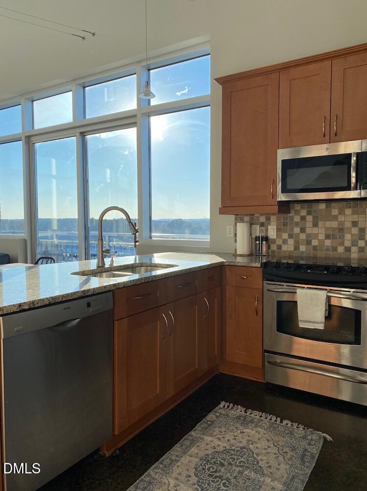 2608 Erwin Road, Unit 430 Durham, NC 27705 - Photo 16 of 43 a kitchen with granite countertop a sink and a stove