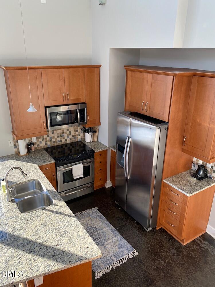 2608 Erwin Road, Unit 430 Durham, NC 27705 - Photo 17 of 43 a kitchen with stainless steel appliances granite countertop a sink refrigerator and microwave