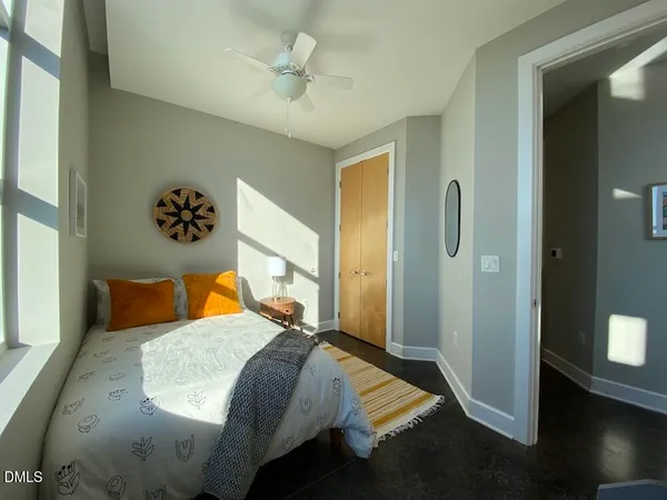 a bedroom with a bed and wooden floor