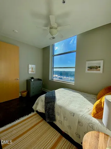 a bedroom with a bed and window