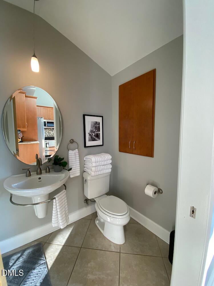 2608 Erwin Road, Unit 430 Durham, NC 27705 - Photo 23 of 43 a bathroom with a toilet sink and mirror