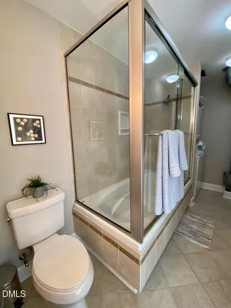 a white toilet sitting next to a bathroom sink