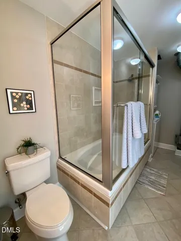 a white toilet sitting next to a bathroom sink