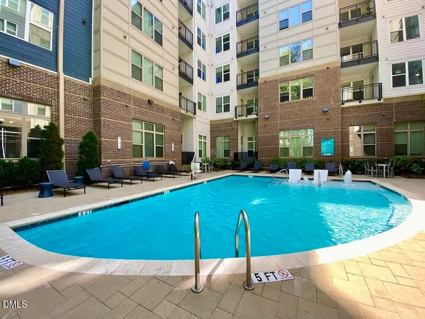 a view of a swimming pool with outdoor seating
