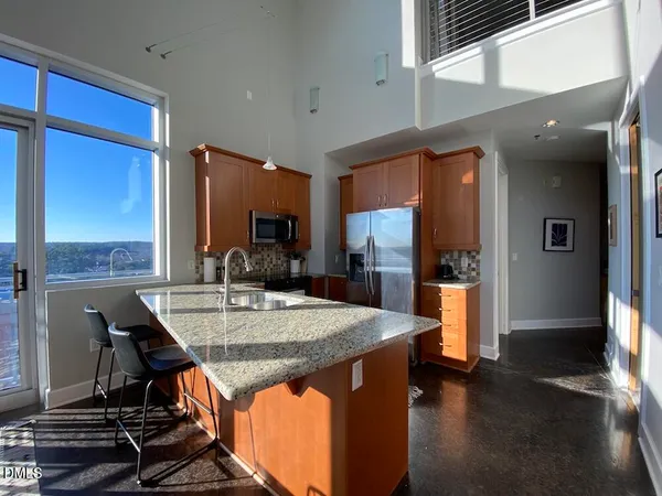 a view of kitchen island dining room cabinets and wooden floor