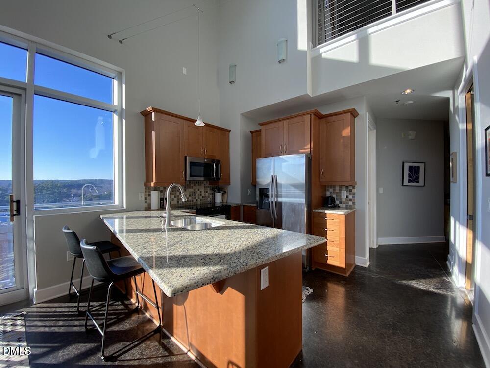 2608 Erwin Road, Unit 430 Durham, NC 27705 - Photo 6 of 43 a view of kitchen island dining room cabinets and wooden floor
