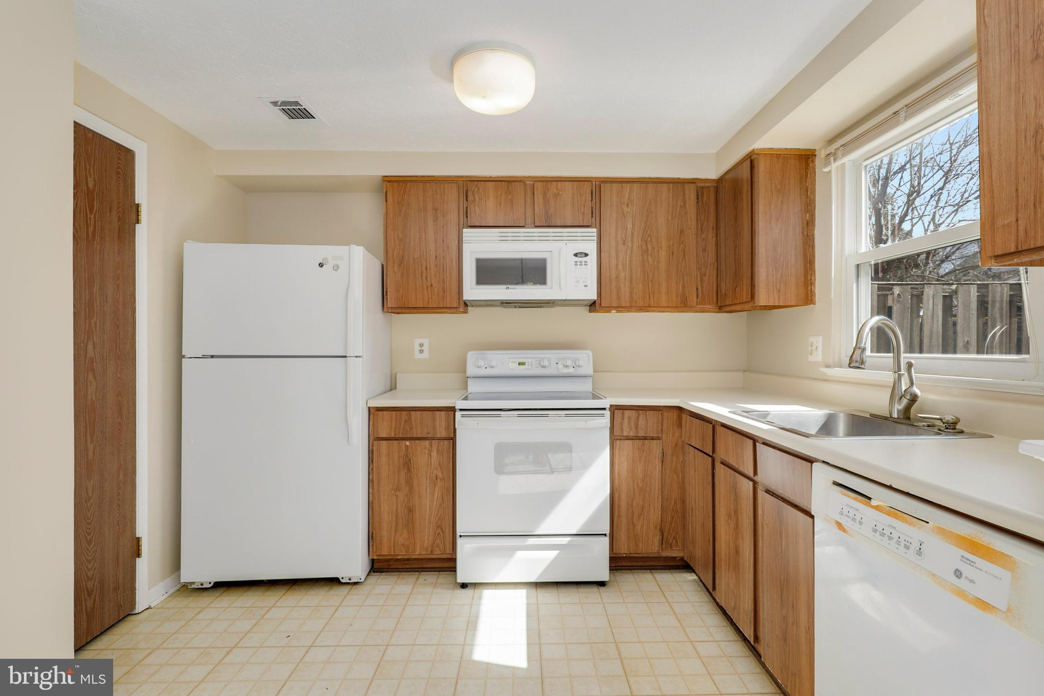 1349 David Lane Frederick, MD 21703 - Photo 7 of 24 a kitchen with a refrigerator sink and cabinets
