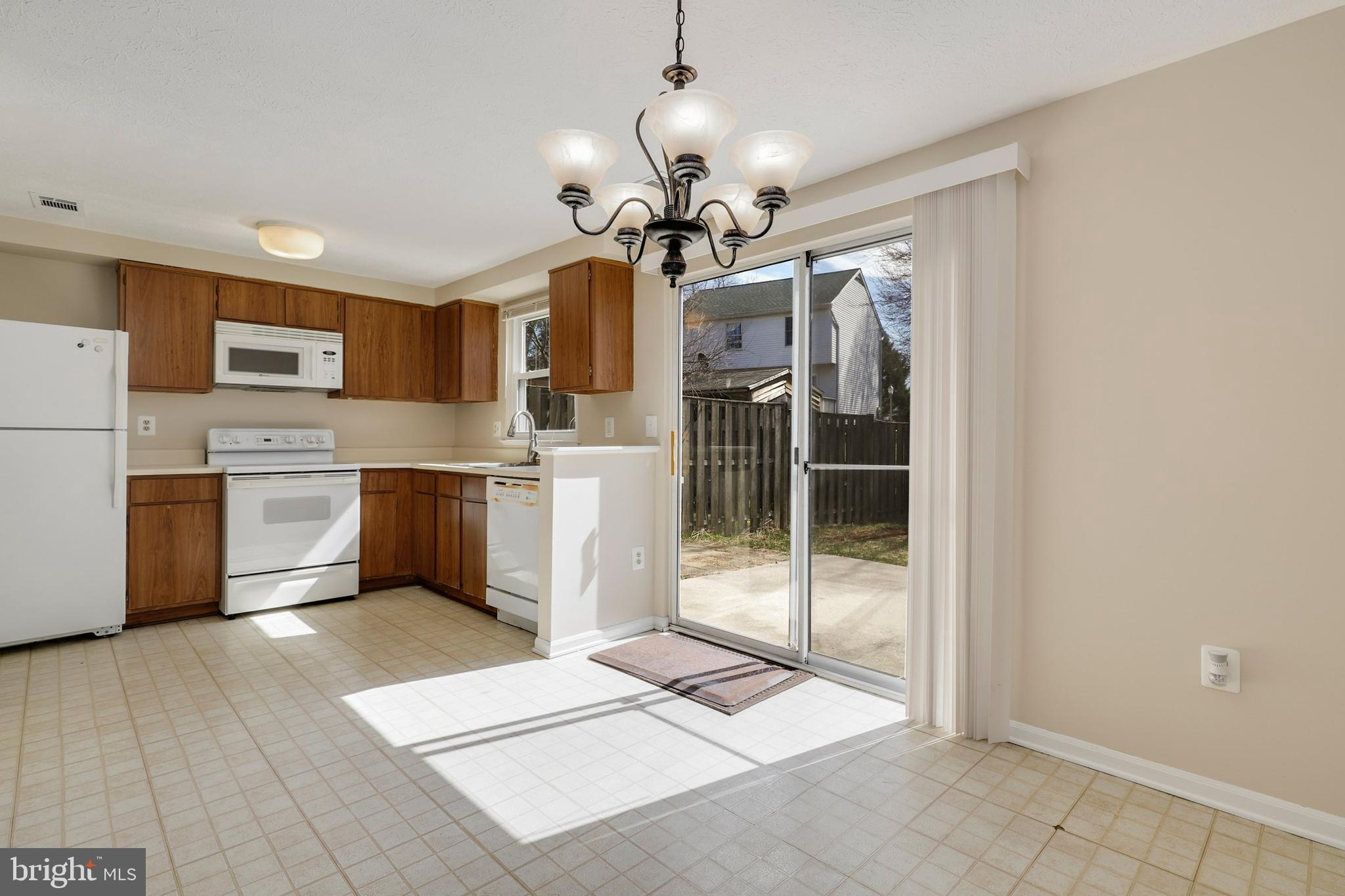 1349 David Lane Frederick, MD 21703 - Photo 10 of 24 a kitchen with stainless steel appliances kitchen island granite countertop a refrigerator a stove top oven a sink and a refrigerator