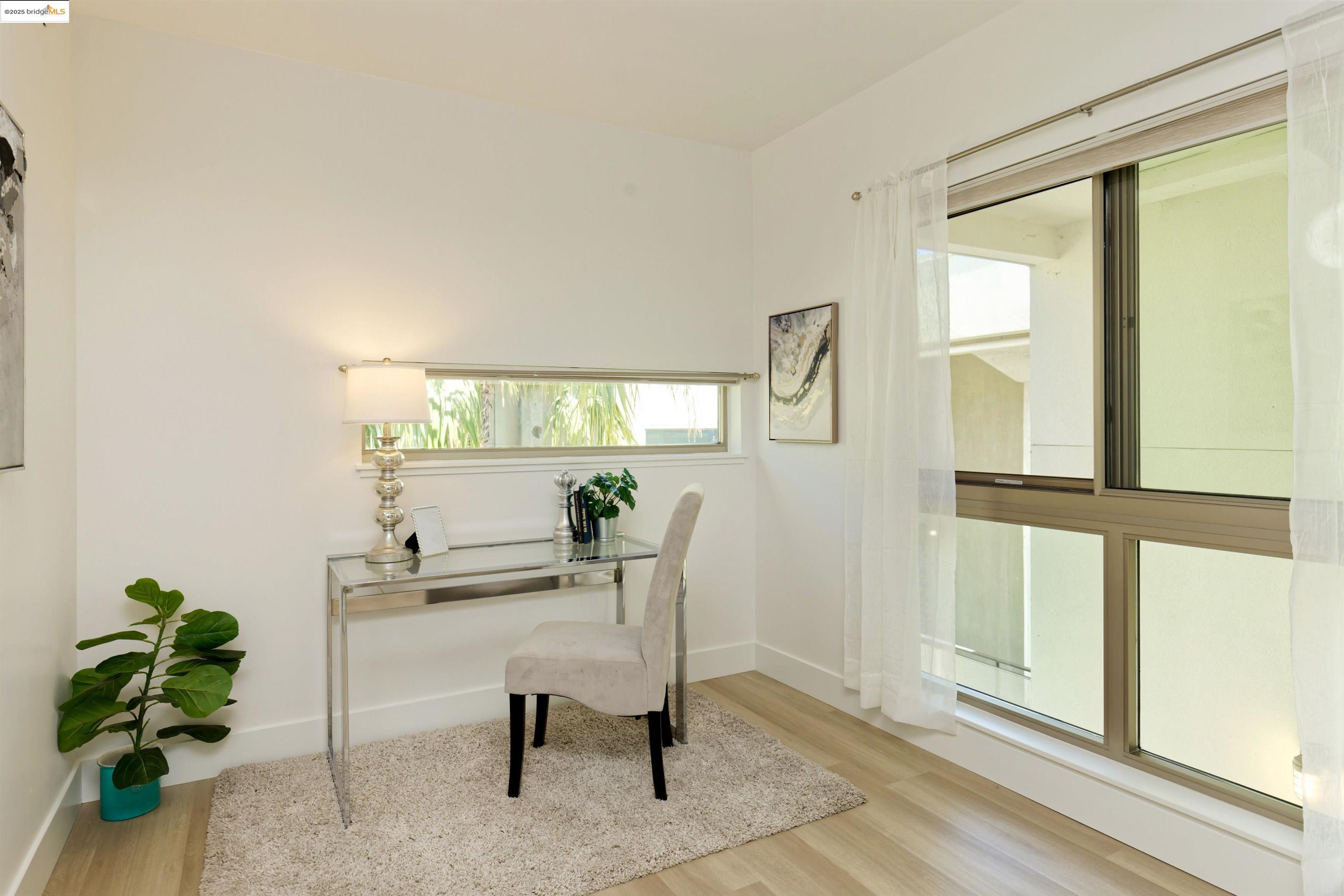 1201 Pine Street, Unit 315 Oakland, CA 94607 - Photo 17 of 41 Home office with light wood-style flooring and baseboards