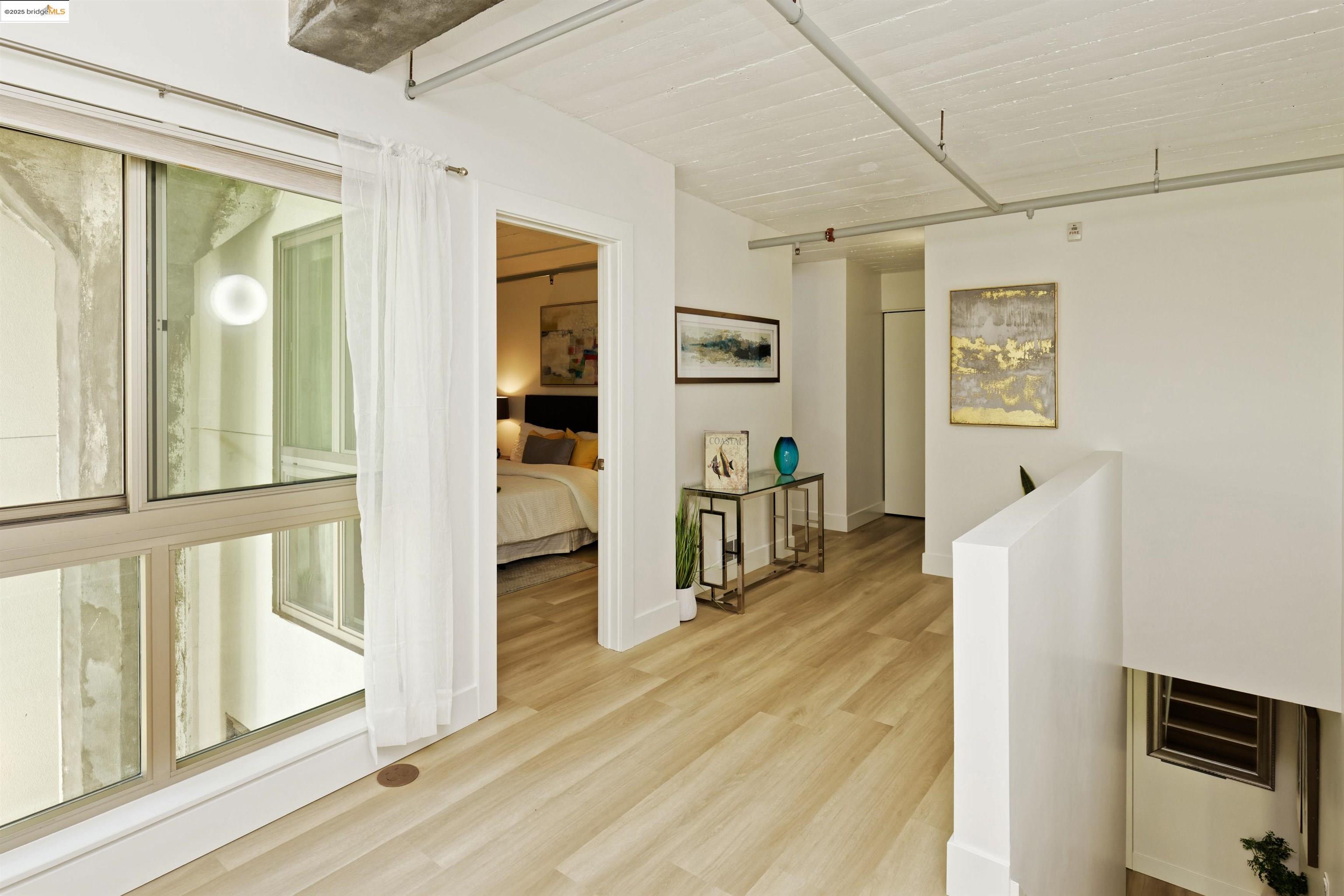 1201 Pine Street, Unit 315 Oakland, CA 94607 - Photo 18 of 41 Hall with an upstairs landing and light wood finished floors