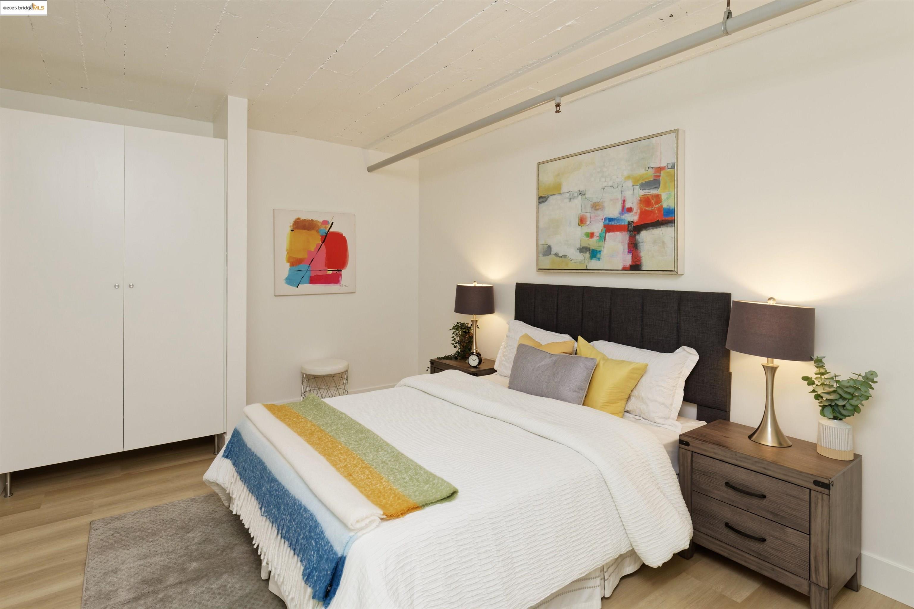 1201 Pine Street, Unit 315 Oakland, CA 94607 - Photo 19 of 41 Bedroom featuring light wood-type flooring
