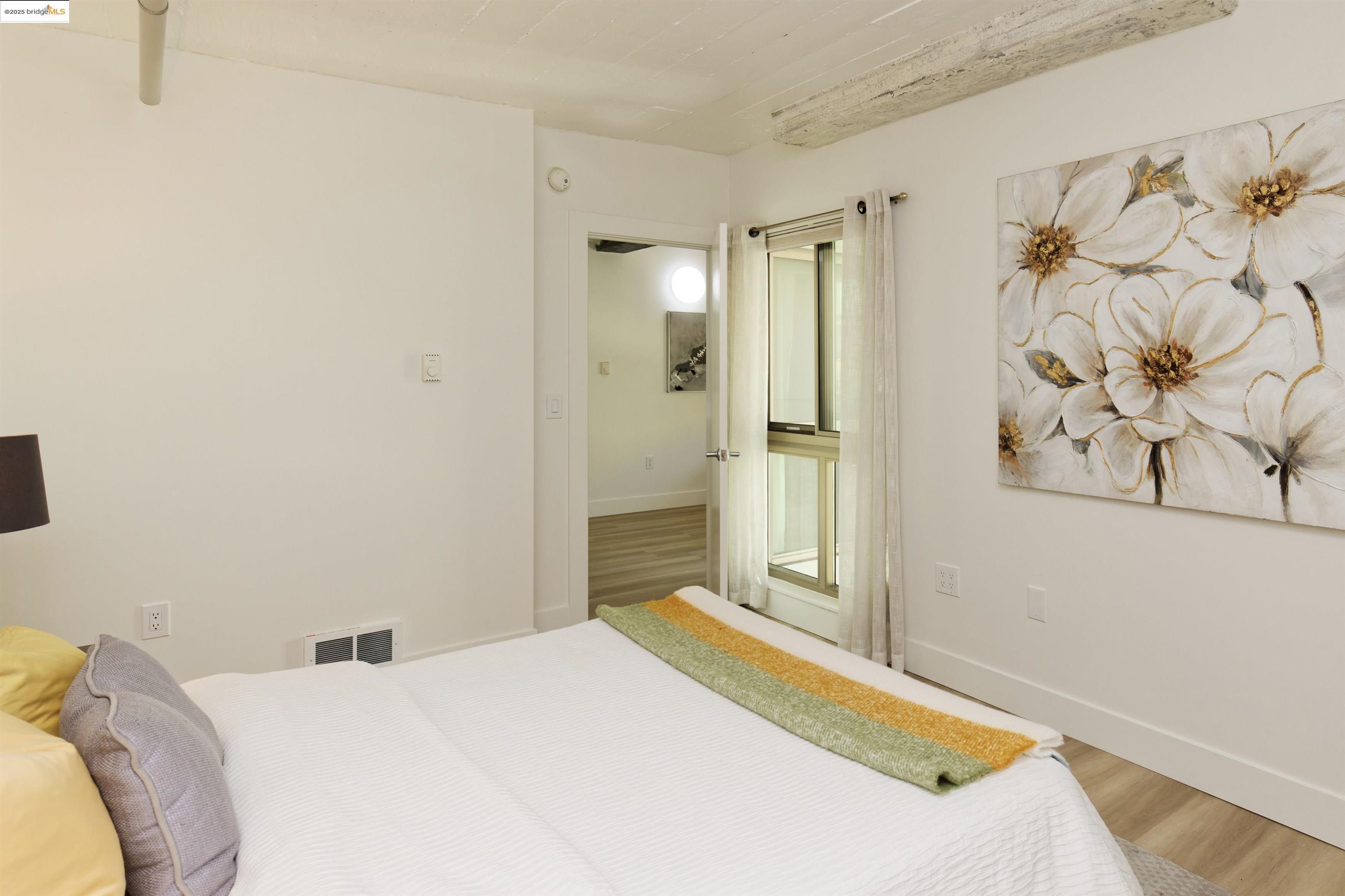 1201 Pine Street, Unit 315 Oakland, CA 94607 - Photo 20 of 41 Bedroom with wood finished floors and baseboards