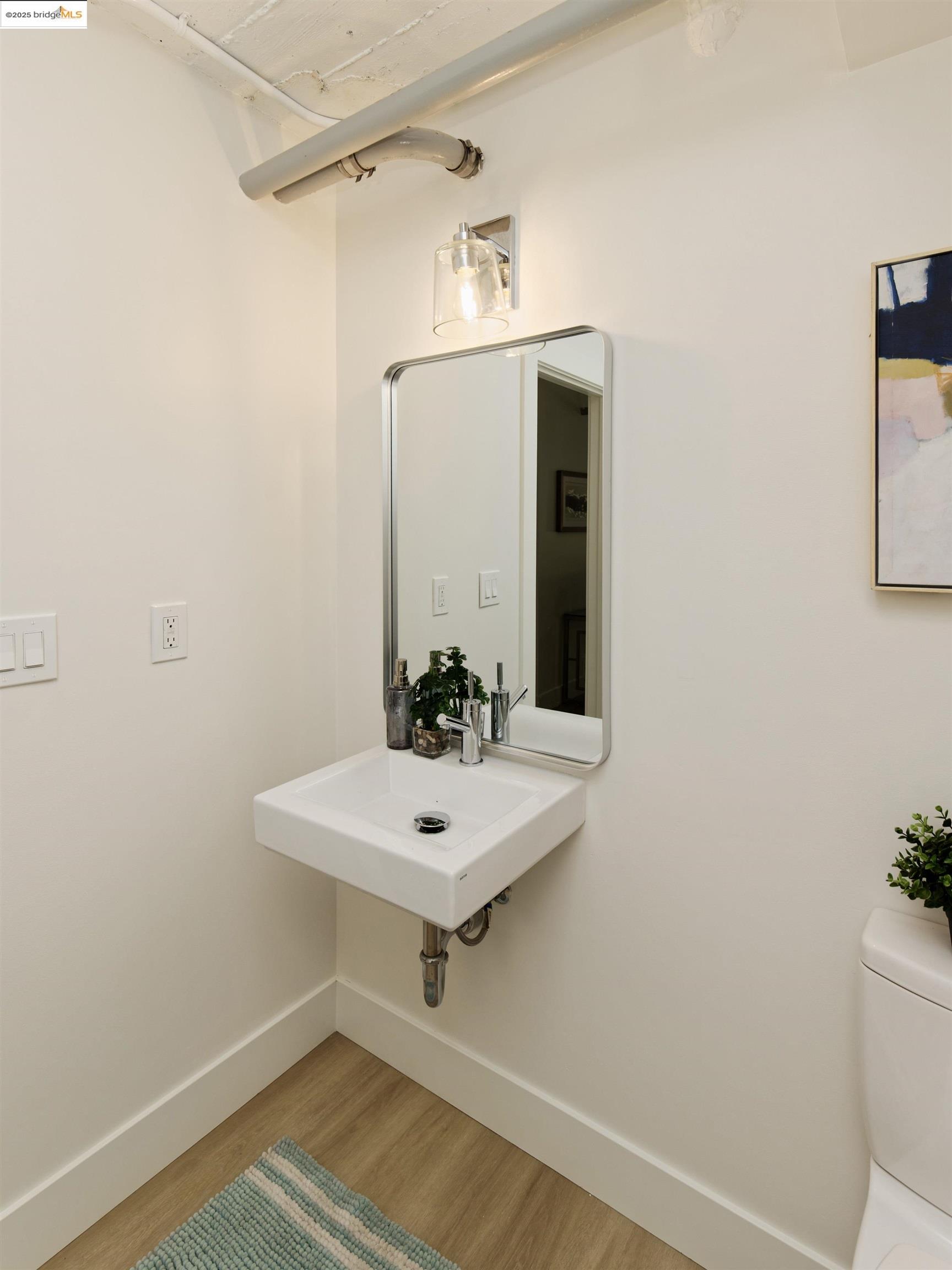 1201 Pine Street, Unit 315 Oakland, CA 94607 - Photo 21 of 41 Bathroom featuring light wood finished floors and baseboards