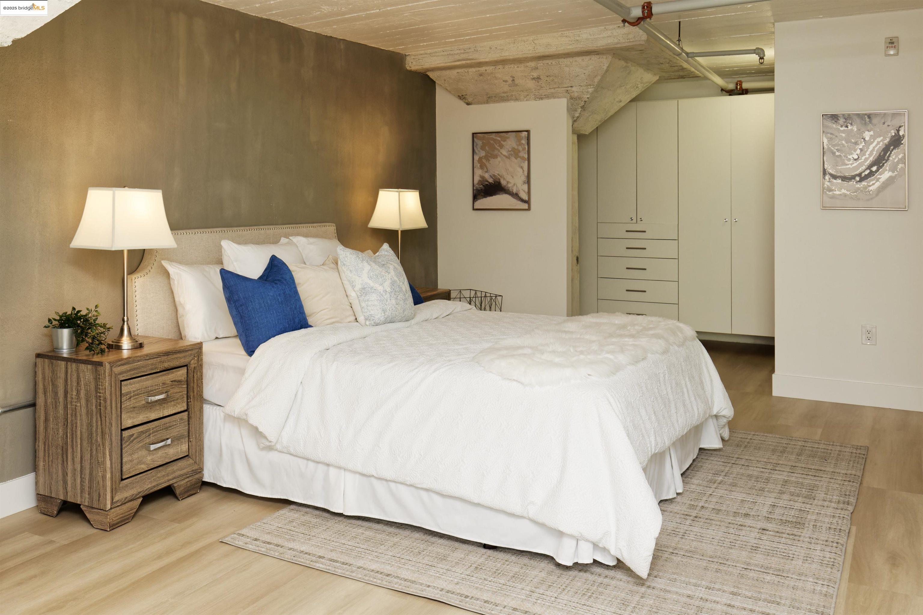 1201 Pine Street, Unit 315 Oakland, CA 94607 - Photo 24 of 41 Bedroom with baseboards and light wood-style floors