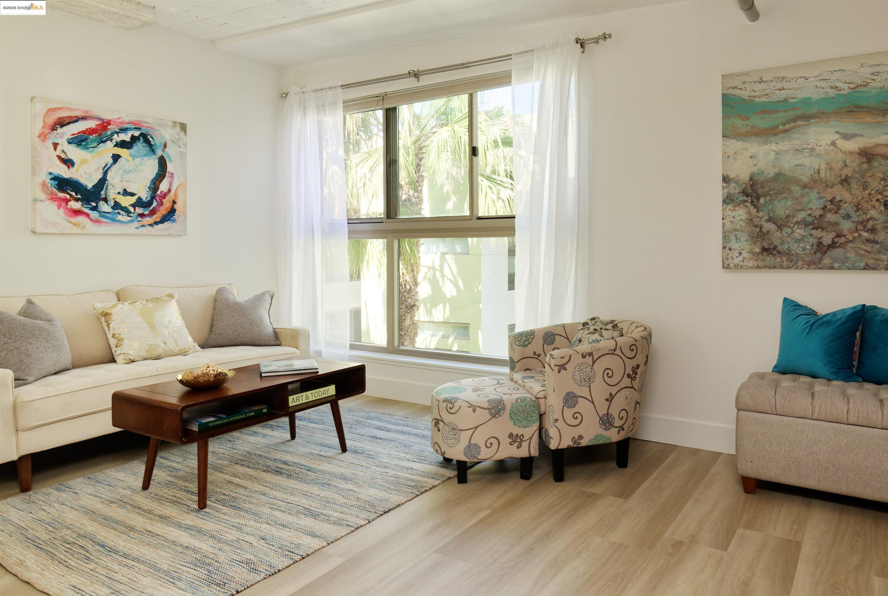 1201 Pine Street, Unit 315 Oakland, CA 94607 - Photo 26 of 41 Living room featuring wood finished floors and baseboards