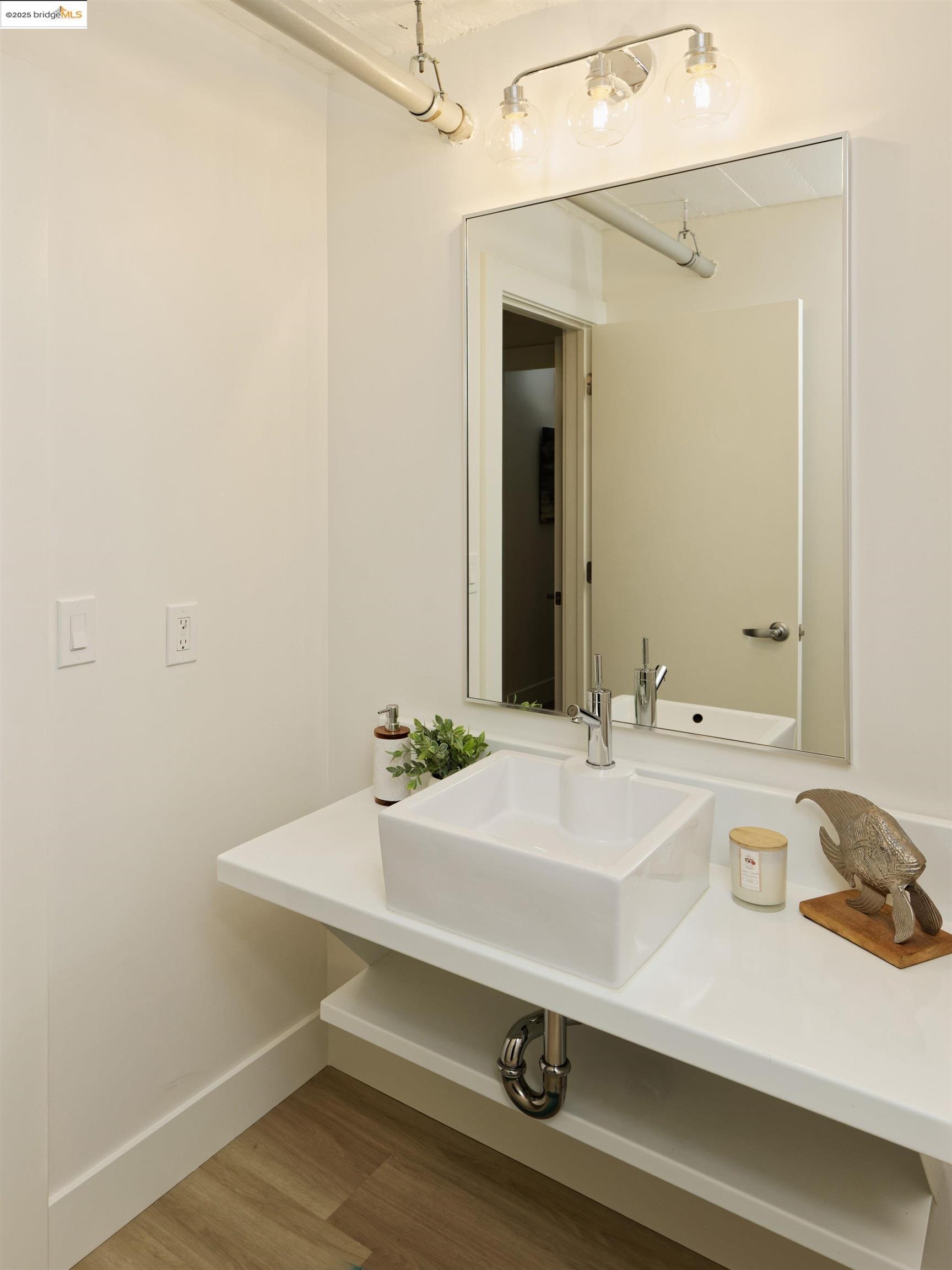 1201 Pine Street, Unit 315 Oakland, CA 94607 - Photo 28 of 41 Bathroom featuring wood finished floors and a sink