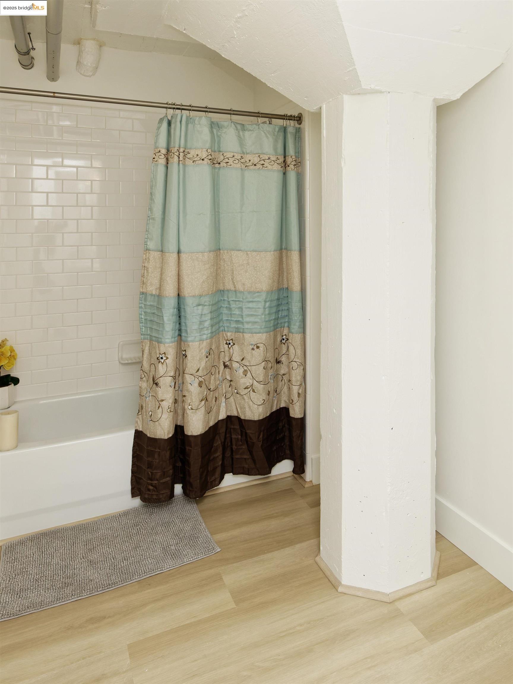 1201 Pine Street, Unit 315 Oakland, CA 94607 - Photo 29 of 41 Full bath with shower / bath combo and wood finished floors