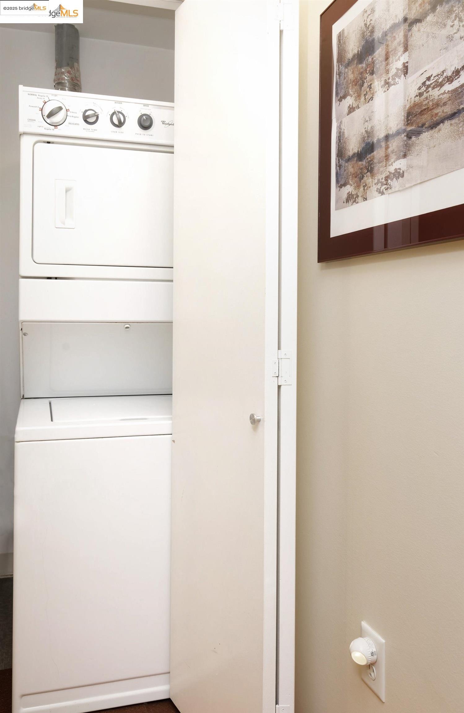 1201 Pine Street, Unit 315 Oakland, CA 94607 - Photo 30 of 41 Laundry room featuring stacked washer / drying machine